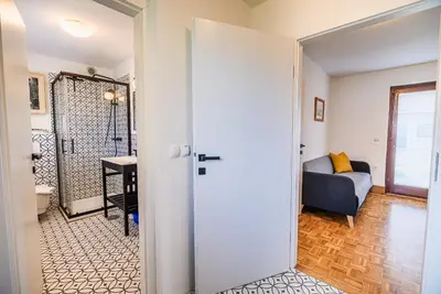 a door leading into a living room with a bed at Spa House Alenka Terme Čatež in Čatež ob Savi