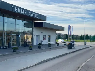 a centre cafe with cars parked outside of it at Spa House Alenka Terme Čatež in Čatež ob Savi