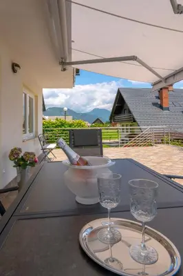 a table with two glasses and a bottle of wine at Mia Dream in Bled