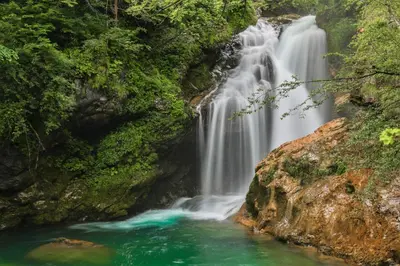 a waterfall in the middle of a river at Mia Dream in Bled
