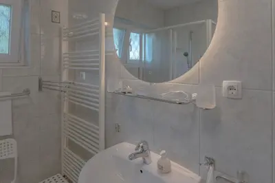 a white bathroom with a sink and a mirror at Mia Dream in Bled