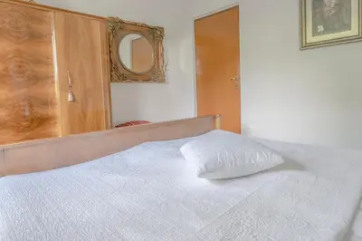 a bedroom with a white bed with a mirror at Mia Dream in Bled