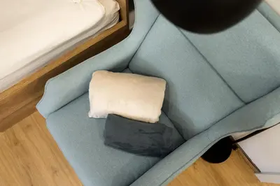 a model of a couch with a pillow on it at Apartments Gros in Radeče