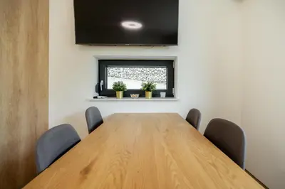 a conference room with a wooden table and chairs at Apartments Gros in Radeče