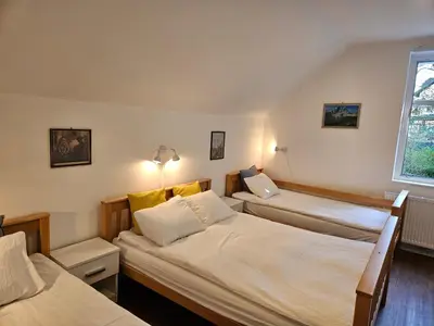 a bedroom with two beds and a window at Hadam's Apartments in Bled