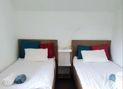 two beds sitting next to each other in a room at Hadam's Apartments in Bled