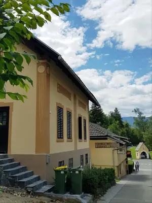 a building with two green trash cans in front of it at Hadam's Apartments in Bled