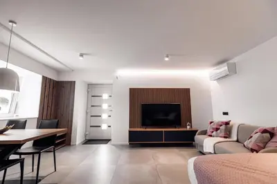 a living room with a couch and a television at APARTMENTS Goldi Superior in Stahovica