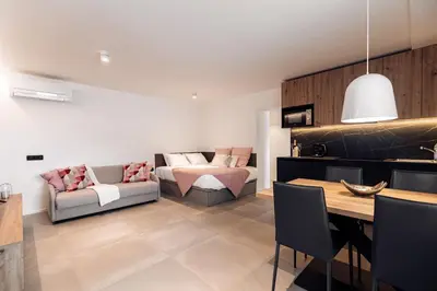 a living room with a couch and a table at APARTMENTS Goldi Superior in Stahovica