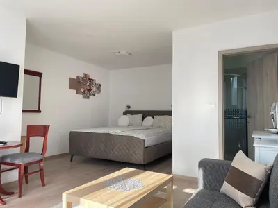 a bedroom with a bed and a table in a room at Ana Rooms Bled in Bled