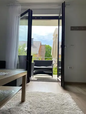a living room with a door open to a patio at Ana Rooms Bled in Bled