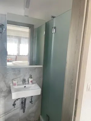 a bathroom with a sink and a mirror at Ana Rooms Bled in Bled