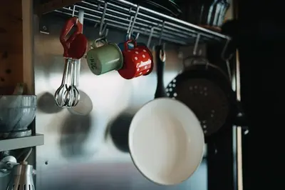 a bunch of kitchen utensils hanging on a rack at Private Cottage near Ljubljana in Škofja Loka