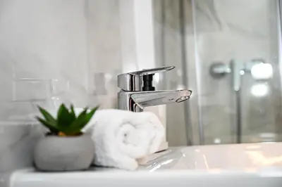 a bathroom sink with a towel and a faucet at Blue apartment with FREE parking in Ljubljana