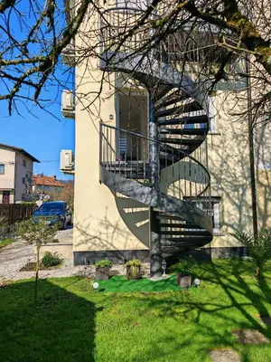 a spiral staircase on the side of a building at Blue apartment with FREE parking in Ljubljana