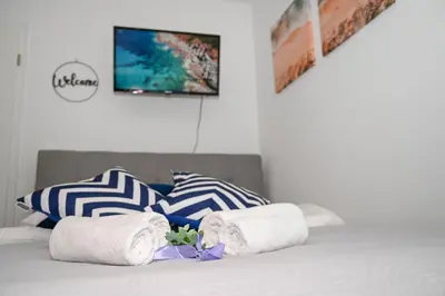 a bedroom with a bed with towels on it at Blue apartment with FREE parking in Ljubljana