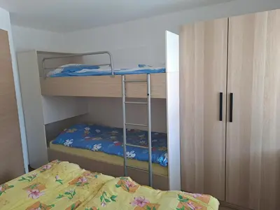 a small bedroom with a bunk bed and a closet at Apartment Danica in Kranjska Gora