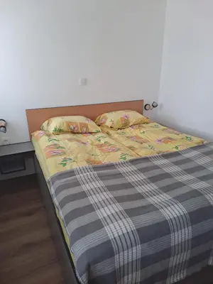 a bed with a blanket and two pillows on it at Apartment Danica in Kranjska Gora