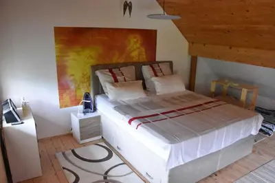 a bedroom with a large bed with a painting on the wall at Apartment in Grabrovec - Koroska Unterkärnten 44968 in Metlika