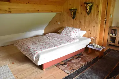 a bedroom with a bed in a room with wooden walls at Apartment in Grabrovec - Koroska Unterkärnten 44968 in Metlika