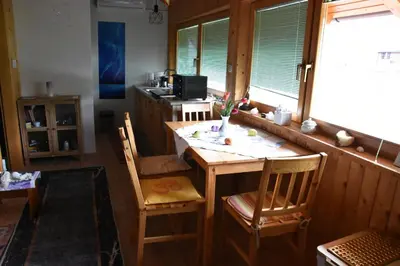 a kitchen with a wooden table and chairs and a window at Apartment in Grabrovec - Koroska Unterkärnten 44968 in Metlika