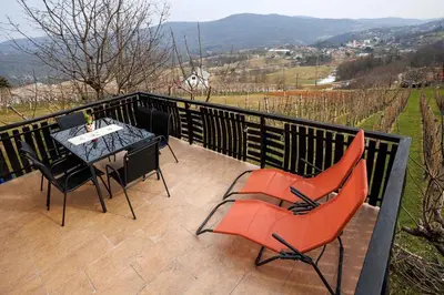 a patio with a table and chairs on a balcony at Holiday home in Adlesici - Dolenjska & Bela krajina Unter- & Weißkrain 44970 in Adlešiči