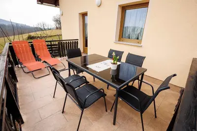a patio with a table and chairs on a balcony at Holiday home in Adlesici - Dolenjska & Bela krajina Unter- & Weißkrain 44970 in Adlešiči