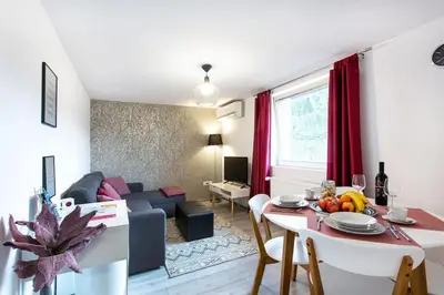 a kitchen and living room with a table and a couch at Ljubljana sLOVEnia + FREEparking & Bikes in Ljubljana