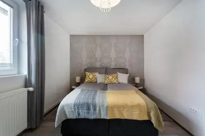 a bedroom with a bed and a chandelier at Ljubljana sLOVEnia + FREEparking & Bikes in Ljubljana