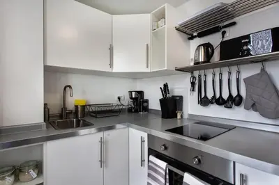 a kitchen with white cabinets and a sink at Ljubljana sLOVEnia + FREEparking & Bikes in Ljubljana