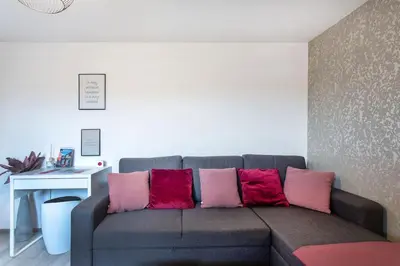 a couch with colorful pillows in a living room at Ljubljana sLOVEnia + FREEparking & Bikes in Ljubljana