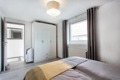 a bedroom with a large bed and a window at Ljubljana sLOVEnia + FREEparking & Bikes in Ljubljana