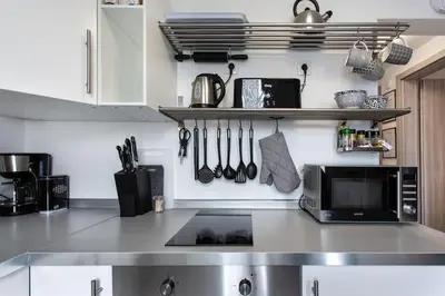 a kitchen with a counter with a microwave and utensils at Ljubljana sLOVEnia + FREEparking & Bikes in Ljubljana