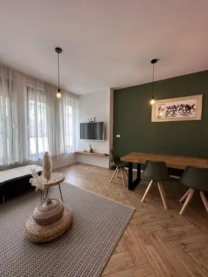 a living room with a table and chairs at Apartmaji Winter Garden Kranjska Gora in Kranjska Gora