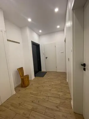 a hallway with white walls and a wooden floor at Apartmaji Winter Garden Kranjska Gora in Kranjska Gora