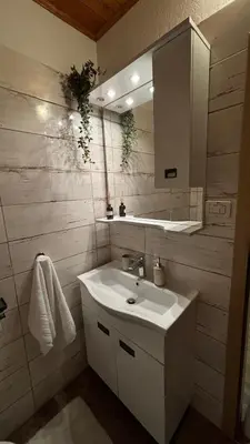 a bathroom with a sink and a mirror at Apartmaji Winter Garden Kranjska Gora in Kranjska Gora