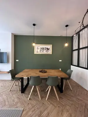 a dining room with a wooden table and chairs at Apartmaji Winter Garden Kranjska Gora in Kranjska Gora