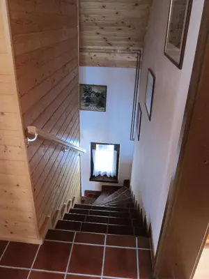 a staircase in a house with wooden walls and floors at Holiday Home Kersnik in Bohinj