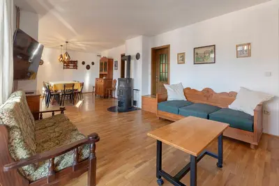 a living room with a couch and a table at Holiday Home Kersnik in Bohinj