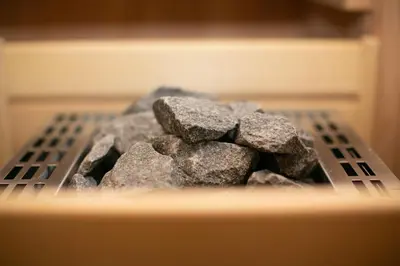 a pile of rocks sitting on top of a stove at Hisa Vukan - Eco House in middle of vineyard with Sauna! in Miklavž pri Ormožu