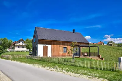 a wooden house on the side of a road at Hisa Vukan - Eco House in middle of vineyard with Sauna! in Miklavž pri Ormožu