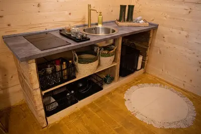 a kitchen with a sink and a counter top at Living Forest Resort in Moravske Toplice