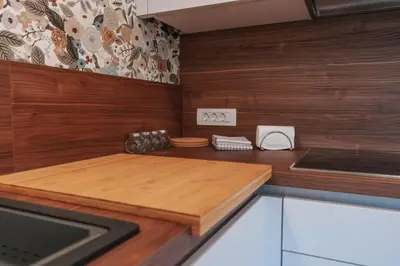 a kitchen with wooden walls and a counter top at APARTMA LAMBERGER in Žirovnica
