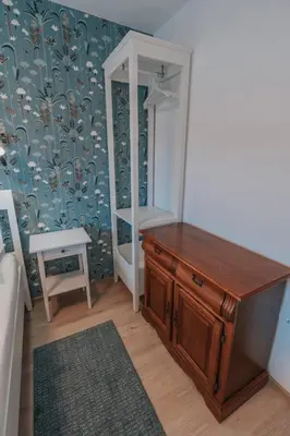 a bathroom with a wooden dresser and a mirror at APARTMA LAMBERGER in Žirovnica
