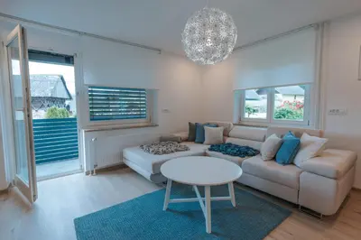 a living room with a couch and a table at APARTMA LAMBERGER in Žirovnica