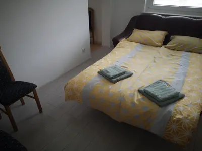 a bedroom with a bed with two towels on it at Sobe Zeleni raj in Podnart