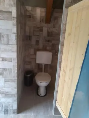 a small bathroom with a toilet in a room at Hiška Zeleni raj in Podnart