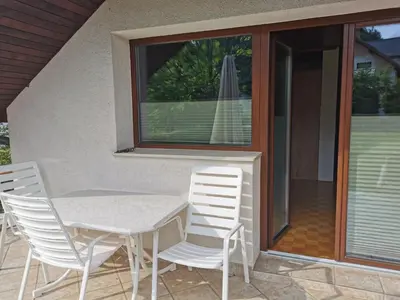 a white table and chairs on a patio at APARTMA MARUŠA in Bled
