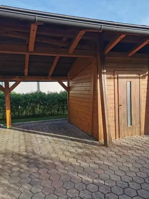 a large wooden building with a roof at APARTMA MARUŠA in Bled