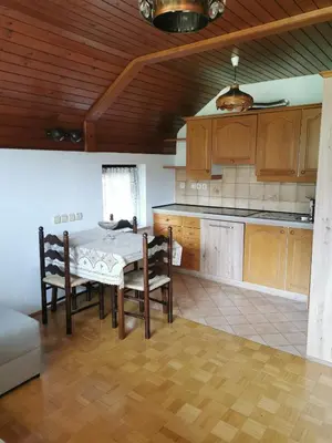 a kitchen with a table and chairs in a room at APARTMA MARUŠA in Bled